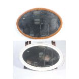 Two oval wall mirrors To include an Edwardian inlaid mahogany mirror and a painted oval mirror.