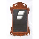 A Chippendale style mahogany wall mirror The rectangular plate within a channelled border and a