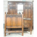 An early 20th Century oak bedroom suite Comprising a double wardrobe with a caddy top above a