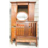 An Edwardian breakfront inlaid mahogany wardrobe With a moulded breakfront cornice above a single