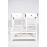 A pair of French style white side tables and a coffee table The side tables both with two drop
