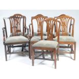 A matched set of seven 19th Century Hepplewhite style dining chairs Each with a pierced splat back