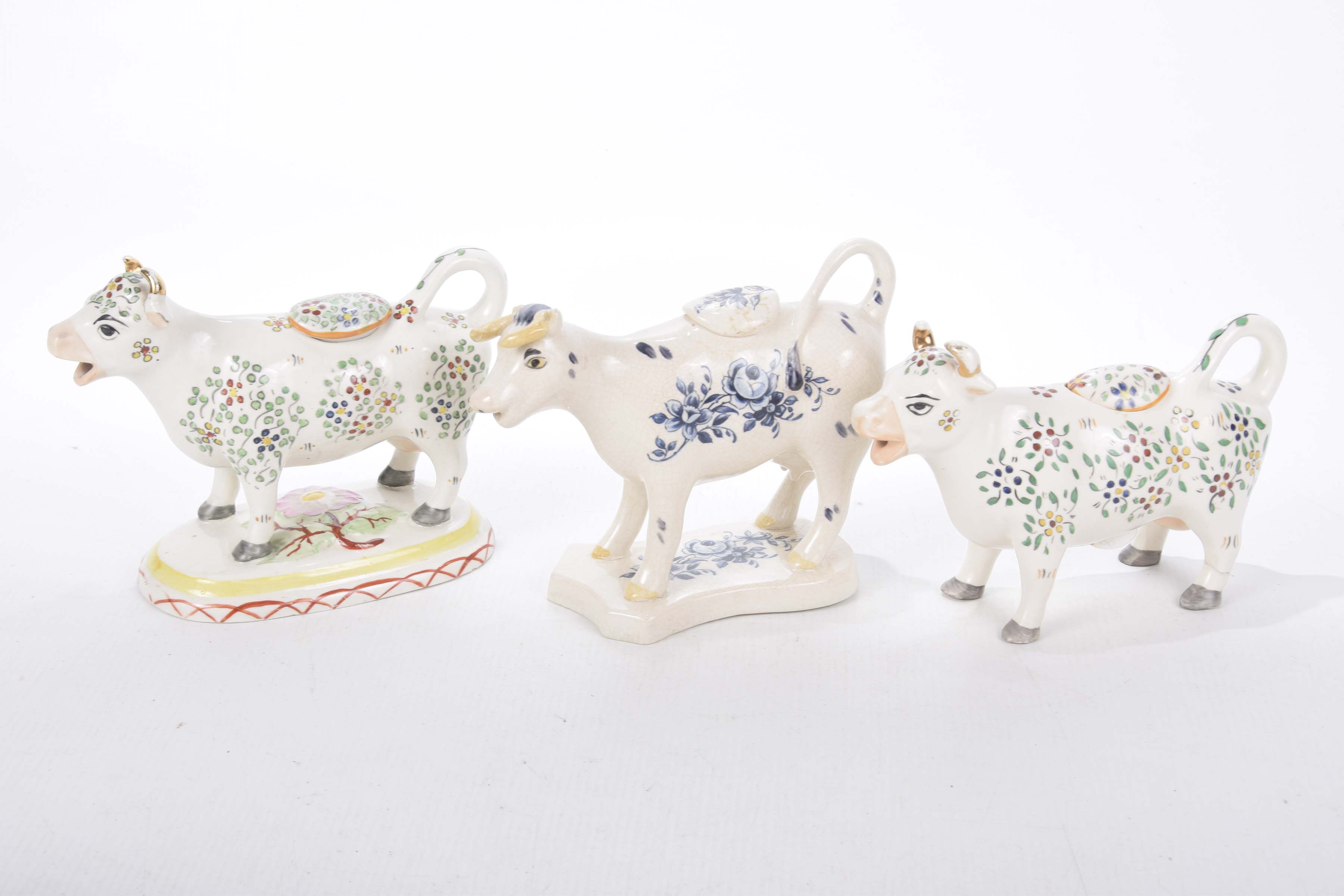 Three Staffordshire cow creamers,