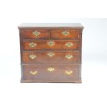 An 18th Century oak and mahogany crossbanded chest of drawers With a rectangular moulded