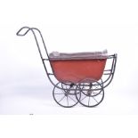 A metal framed dolls pram With four metal spoked wheels,