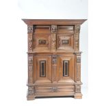 A Victorian Flemish oak court cupboard The upper section with a moulded cornice above three carved