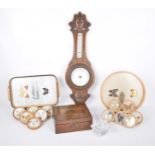 An oak barometer early 20th century With a carved case and white dial,