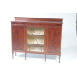 An Edwardian inlaid mahogany display cabinet The rectangular top with a raised back and inlaid