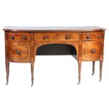 A George III mahogany bow front sideboard Having a shaped top with a reeded edge above a long
