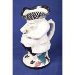 A 19th Century Staffordshire Toby jug The figure painted with a lattice design tricorn hat and