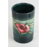 A Walter Moorcroft cylindrical vase Decorated in the 'Lily' pattern on a green and blue ground,