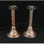 A pair of Arts & Crafts A E Jones copper candlesticks Each having planished decoration with applied