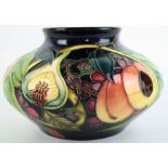 A modern Moorcroft vase of squat circular form Decorated in the 'Queens Choice' pattern,