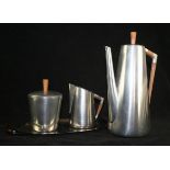 An Art Deco style Dutch pewter tea set Having teak mounts, by Royal Holland Pewter,