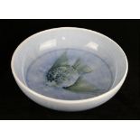 A Walter Moorcroft pottery bowl Decorated with a fish to centre on a light blue ground,