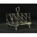 An Arts & Crafts silver-plated four bar toast rack Having central diamond style decoration,