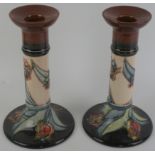 A pair of modern Moorcroft candlesticks Decorated in the 'Red Tulip' pattern, factory marks to base,