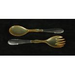 A pair of Georg Jensen 830 silver and horn salad servers Having cast beaded decoration to handles,