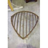 A cast iron hayrack Of convex form, with slatted open work front and exterior frame, 79cm high.