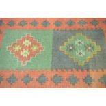A contemporary Turkish Kilim style rug The orange ground rug with two central reserve filled with