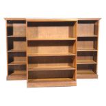 An early 20th Century three section oak open bookcase Each section with three enclosed shelves,