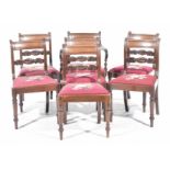 A set of seven George IV mahogany dining chairs Each with a concave top rail above a scrolling