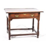 An 18th Century oak side table With a two plank moulded top above a single frieze drawer with