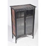 An early 20th Century Japanned display cabinet The rectangular top painted with birds amongst