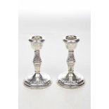 A pair of Silver Candlesticks The spreading circular base rising to a knopped and turned stem