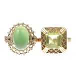 Two gem-set cocktail rings In unmarked precious pink metal, both centering green stones,
