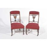 A pair of Victorian rosewood low seat chairs Each chair with a padded rail above a shield shaped