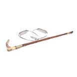 An Adney and Swaine bamboo riding crop With carved antler handle extending to a bamboo stick,