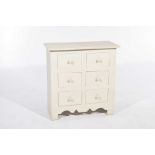 A rustic painted hardwood chest With an arrangement of six deep drawers each with knob handles