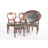A set of four Victorian mahogany balloon back dining chairs Each with a stuff-over bowfront seat