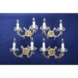 A set of three Venetian style cut class twin handled wall sconces Each with a central scrolling