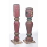 A matched pair of rustic painted cricket style candlesticks Each formed from a table leg with