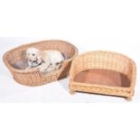 Two vintage wickerwork dog beds Largest approximately 90cm wide.