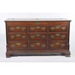 A George III oak and mahogany crossbanded Lancashire mule chest The rectangular crossbanded hinged