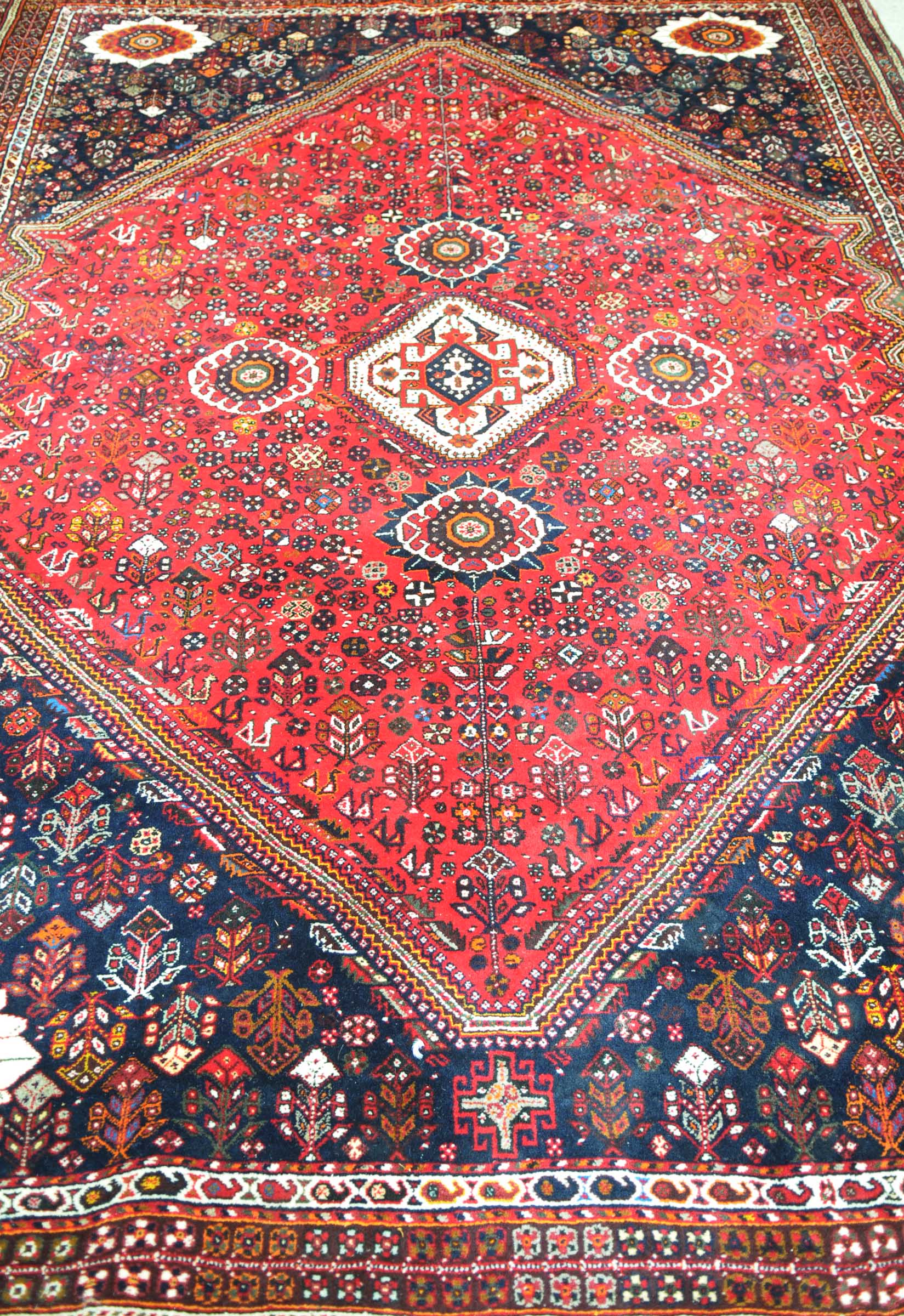 A Kashgai style medallion rug The central quatrefoil design further adorned with flower head