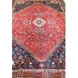 A Kashgai style medallion rug The central quatrefoil design further adorned with flower head