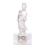 A contemporary Chinese Blanc-de-chine figure of Guanyin Modelled on a raised lotus base,