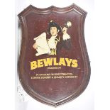 A large shield shaped wooden shop sign For 'Bewlays purveyors of Fine Tobaccos,