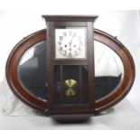 A 1930's oak cased wall clock The dark oak case with silvered dial and Arabic numerals,