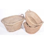 A graduated set of three wicker laundry or log baskets Each of oval form, with twin handles,