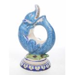 An unusual faience glazed jug In the form of a mythical animal/fish creature seated on a tortoise