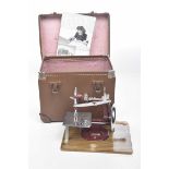 A vintage Essex miniature sewing machine The red painted metal and chromed small side sewing