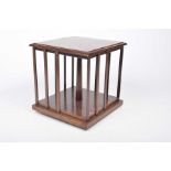 An early 20th Century mahogany revolving bookstand The stepped square base,