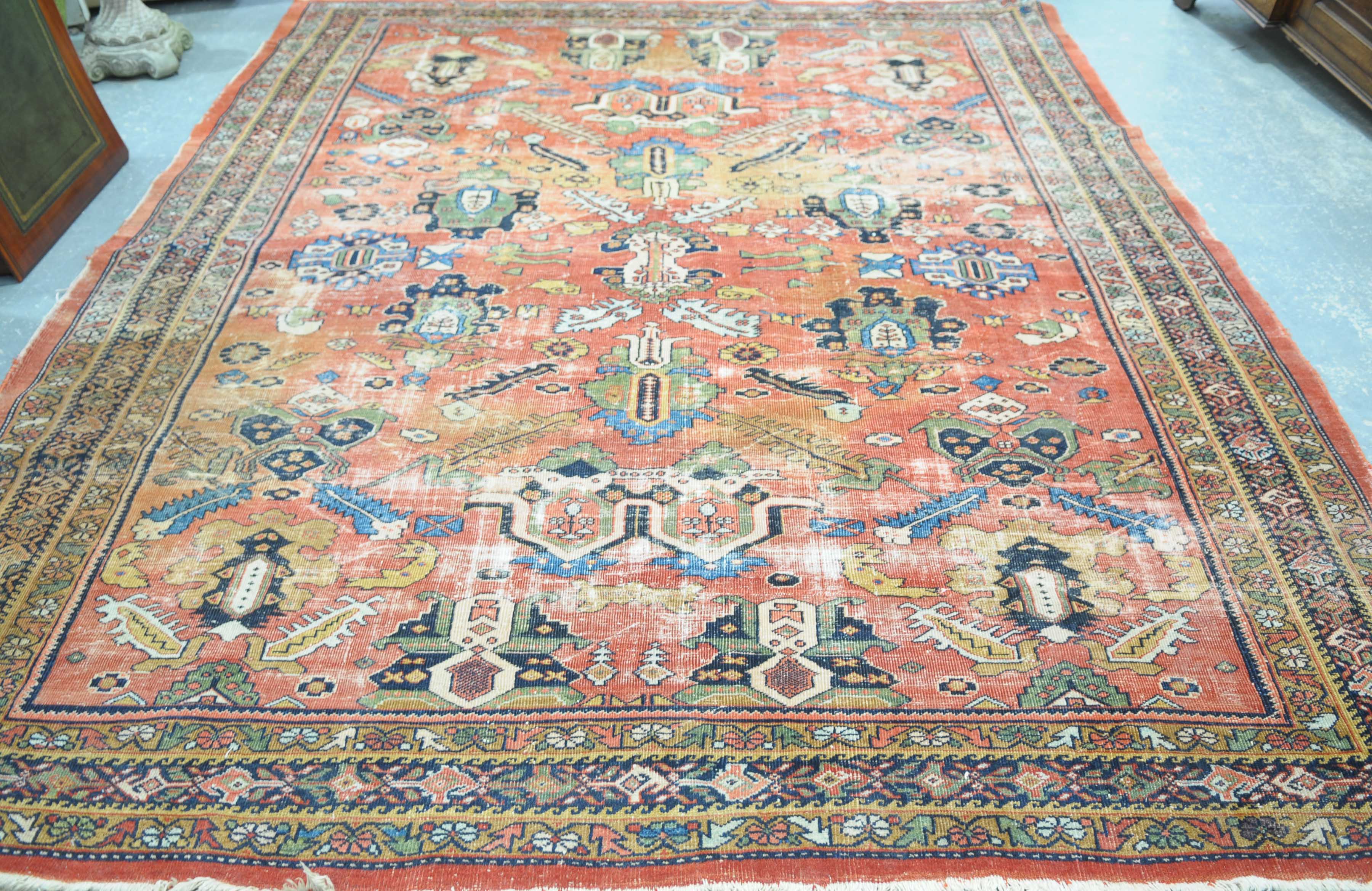 A woven Bokhara style rug The orange ground rug with large central reserve detailed with a series