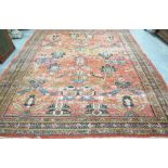 A woven Bokhara style rug The orange ground rug with large central reserve detailed with a series
