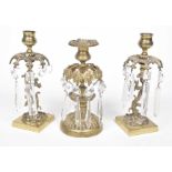 A pair of 19th Century gilt metal Rococo style candlesticks The central stem of each raised on a
